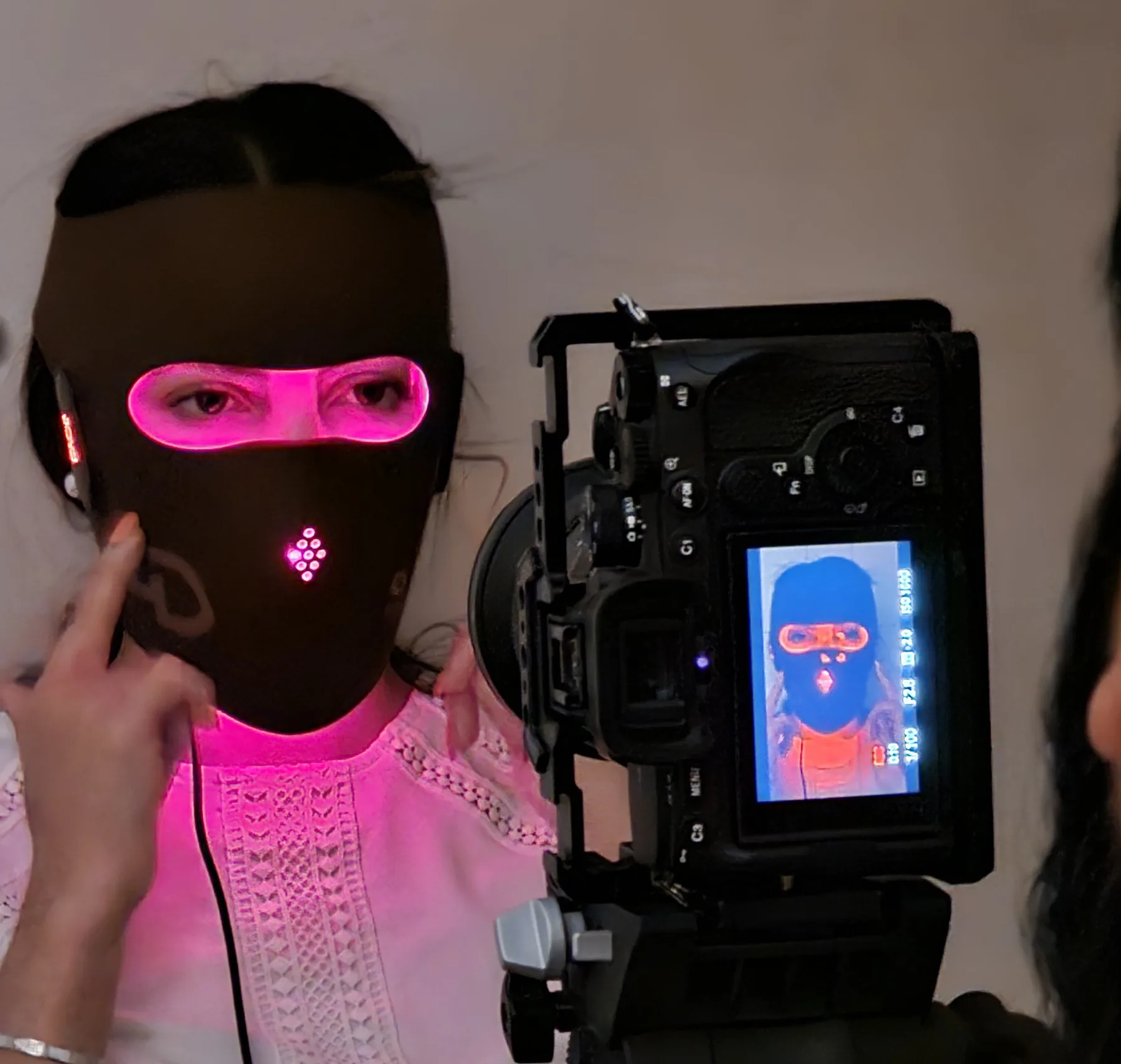 Behind the scenes of an illuminated beauty mask video shoot